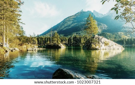 Fairy-tale  lake Hintersee in sunny day, with Perfect sky reflective in the water. Magic Painterly Scene in European Alps. Popular Photography Locations. Ideas for Great Travels. Instagram Filter