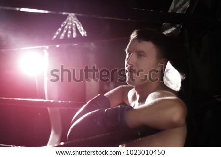 Professional boxer having break during training in ring