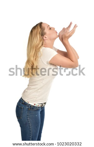3/4 portrait of blonde girl wearing white shirt. isolated on white background.