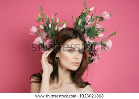  floristry, young woman with a bouquet of flowers on a pink background                              