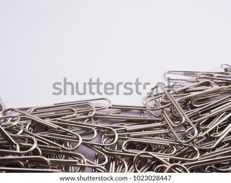 group steel paperclips on white background.