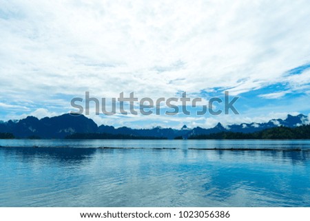 Beautiful blue sky with clouds over the lake and hill view.