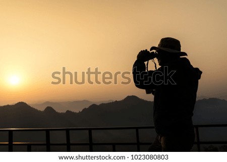Silhouette of a photographer who was happy to shoot in the morning, a beautiful nature 