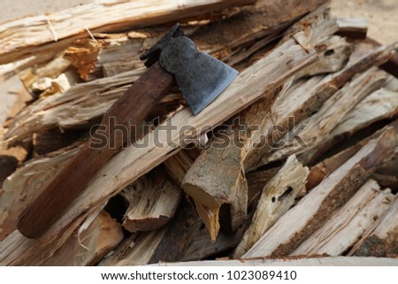 Ax and firewood are prepared for winter. Royalty-Free Stock Photo #1023089410