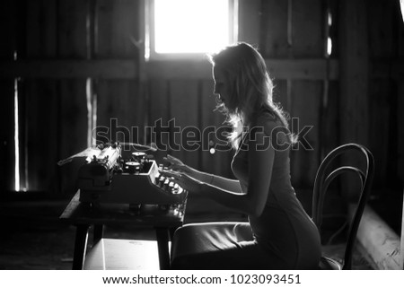 Silhouette of a beautiful girl in a dress on the background of a window in an old house