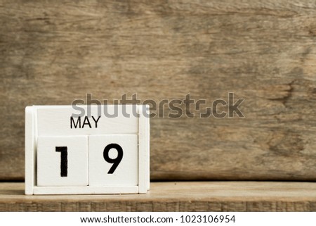White block calendar present date 19 and month May on wood background