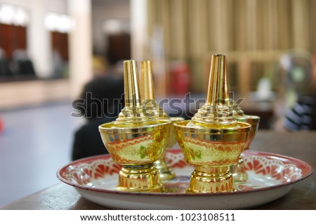 Fourth gold pouring water are on the vintage plate in the temple. The picture concepts are passing the good things to the spirit, buddhist culture, ceremony, honor.