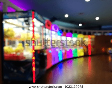 blurred place for play a game child in department store. Playground with colorful neon light and bokeh light