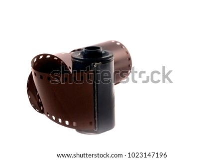 a roll of retro camera film cartridge isolated on white background