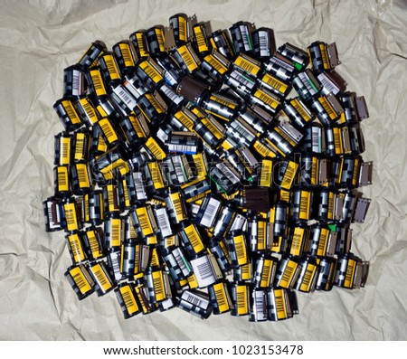 Many different film cartridges rolls on an old vintage paper background