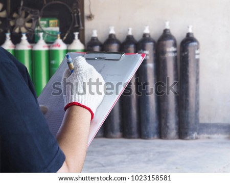  Female technician check Oxygen tank industry Royalty-Free Stock Photo #1023158581