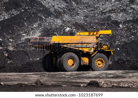 Big dump truck or Mining truck is mining machinery, or mining equipment to transport coal from open-pit or open-cast mine as the Coal Production. This picture show dump truck on open-pit coal mine.