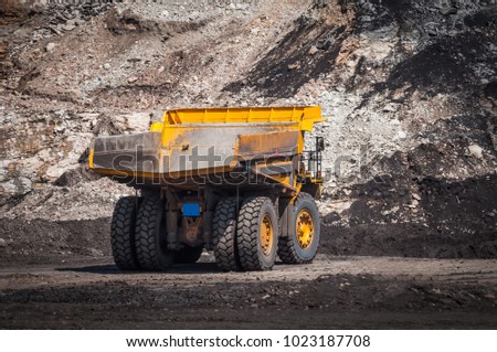 Big dump truck or Mining truck is mining machinery, or mining equipment to transport coal from open-pit or open-cast mine as the Coal Production. This picture show dump truck on open-pit coal mine.