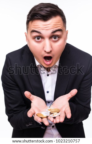 Portrait of a screaming businessman looking at golden bitcoins in his arms isolated
