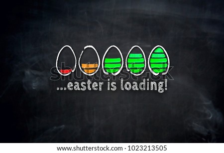 Easter is loading concept with eggs on blackboard. Royalty-Free Stock Photo #1023213505