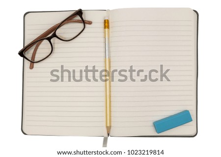 The top view of the notebook opens the middle page and glasses and a pencil and eraser.