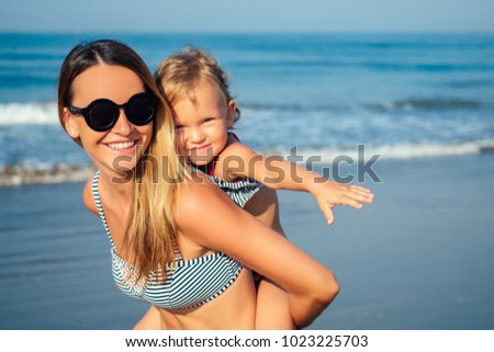 mother daughter having fun resting on the beach