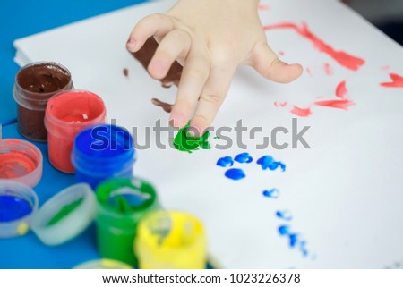 Child painting with fingers