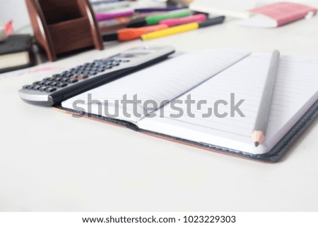 Black open leather covered diary with calculator and pen