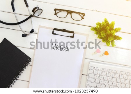 Medical concept - Stethoscope with notebook and clipboard writing medical