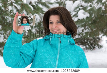 Woman is making a salfi in snowy forest