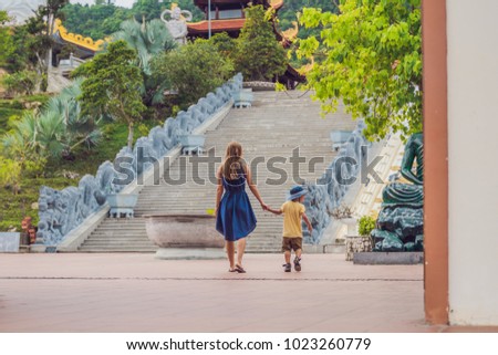 Happy tourists mom and son in Pagoda. Travel to Asia concept. Traveling with a baby concept.