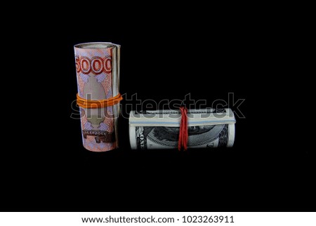 Rubles and dollars on a black background close-up