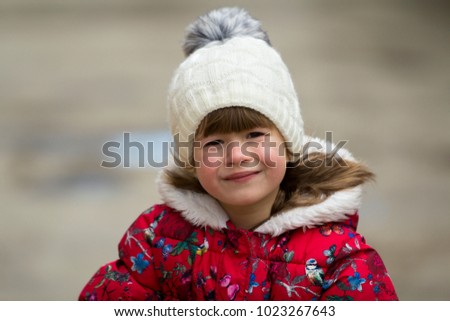Cute little girl in warm clothes on white background