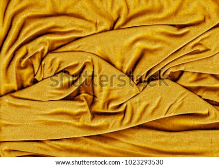 Wrinkled yellow fabric textured background 