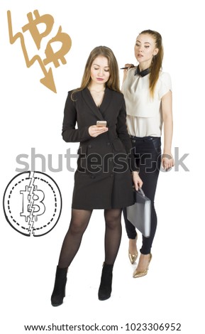 Beautiful women standing over white background with bitcoin sketches and talking. Virtual money concept. Cryptocurrency