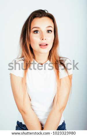 young pretty teenage girl posing cheerful happy smiling on white background, lifestyle people concept