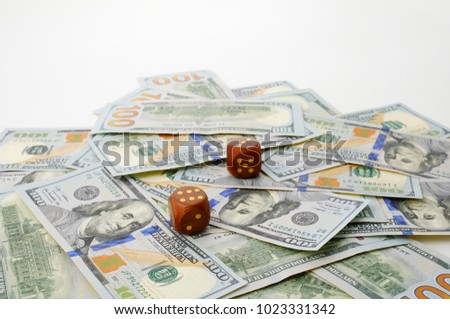 one hundred dollars banknotes and two lucky dice. concept of game and luck.