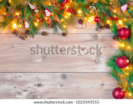 Holidays: Christmas ornaments with copy space. Green border of cedar and pine cones.
