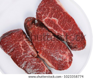 three fresh raw marble beef meat sirloin porterhouse steak on big ceramic cooking pan isolated on white background