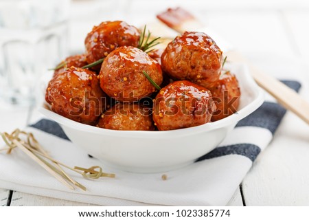 Chicken Meatballs with glaze on wooden table. Royalty-Free Stock Photo #1023385774