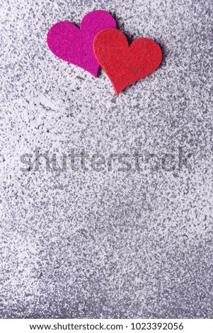 Pink and red hearts on Valentines day over snowy background.