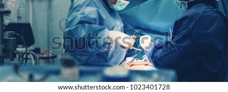Medical team of surgeons in hospital doing minimal invasive surgical interventions. Surgery operating room with electrocautery equipment for cardiovascular emergency surgery center. Royalty-Free Stock Photo #1023401728