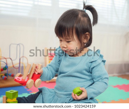 baby girl play toy at home