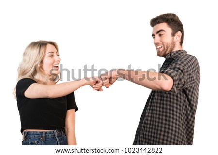 The happy couple greeting with fists on the white background