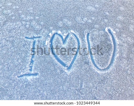 Writing text "I love you" and heart on Ice nature background textured. Greeting card for Valentine's Day.