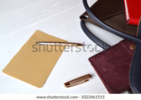 Business bag and empty paper on the desk. Business flat lay.