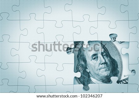 Hundred dollar under puzzle pieces extreme closeup