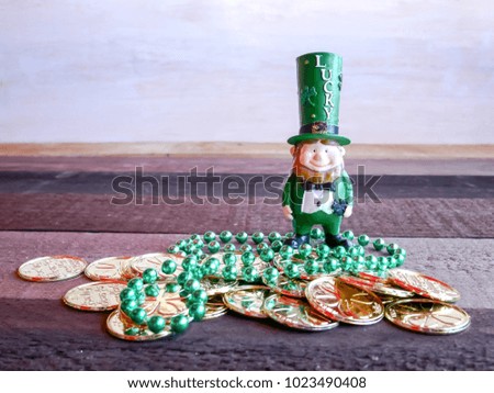 Saint Patricks Day  with lucky toy and pot of gold on old wooden table.image for "Happy St. Patricks Day" concept.