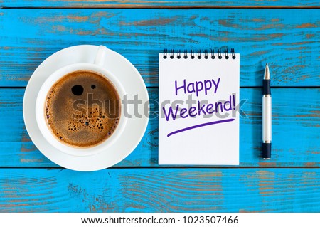 Happy weekend wishes with morning coffee cup at blue wooden rustic background, flat lay