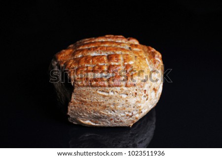 Scone mini bread on black reflective studio background. Isolated black shiny mirror mirrored background for every concept.