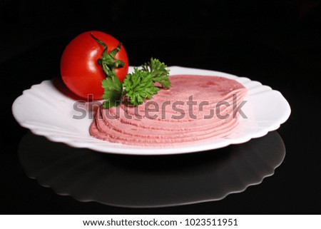 Sliced ham pork meat on black reflective studio background. Isolated black shiny mirror mirrored background for every concept.