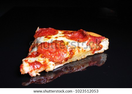 American pizza on black reflective studio background. Isolated black shiny mirror mirrored background for every concept..