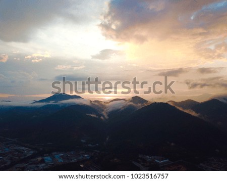 Aerial view of sky and mountain during sunset. Haze, selective focus and crop fragment.
