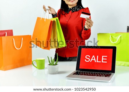 Online shopping, Shopaholic woman with sale promotion sign on laptop computer, E-business commercial concept.