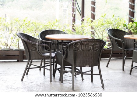 Wood chair and table in the restaurant on nature background with copy space.